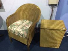 A gold Lloyd Loom chair and linen box