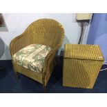 A gold Lloyd Loom chair and linen box