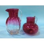 Two Cranberry glass jugs