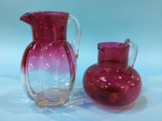 Two Cranberry glass jugs