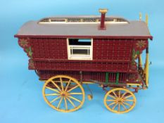A model wood and decoratively painted Romany Caravan. 45cm length, 80cm width