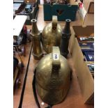 Two reproduction brass Fireman's helmets and two hose nozzles