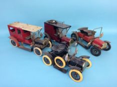 A box containing four model vintage vehicles