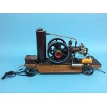 A single cylinder petrol engine model 'Shell', on a wooden base, with wheels. 63cm length x 34cm