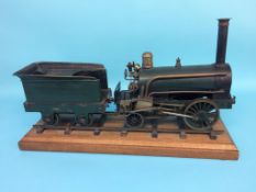 A 3 ½ inch gauge live model of an early steam locomotive, 2-2-0, with green livery