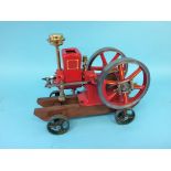 A hopper fed horizontal model engine, Amanco Waterloo Iowa, USA, on wood support with wheels. 34cm x