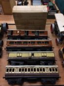 Four tin plate model railway carriages