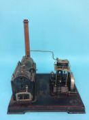 A twin cylinder model spirit fired engine and pump, labelled 'D.C. Made in Germany', 35cm width x