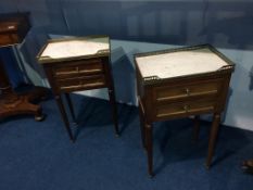 A pair of marble top bedside cabinets