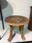 A hardwood African style occasional table, inlaid with beads