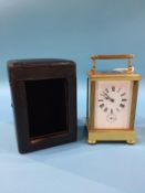 A brass carriage clock, in fitted leather case