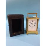 A brass carriage clock, in fitted leather case