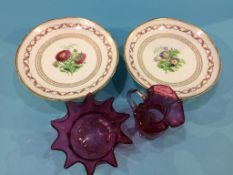 A cranberry glass jug and two dishes