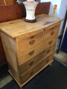 A pine chest of five drawers