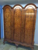 A walnut Queen Anne Style triple door wardrobe