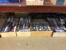 Four boxes of assorted DVDs, to include the Hobbit, Saw etc.