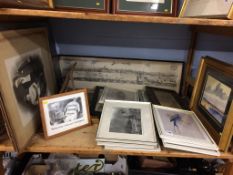 A shelf of assorted prints and pictures