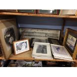 A shelf of assorted prints and pictures