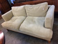 A green two seater sofa
