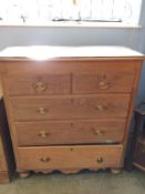 A pine chest of five drawers