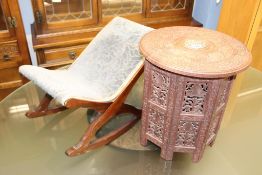 A small Indian carved circular table and a stool