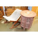 A small Indian carved circular table and a stool
