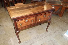 An oak two drawer lowboy with cabriole legs, 105cm