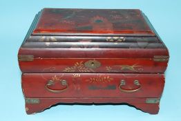 An Oriental red lacquered work box/jewellery casket. 30cm wide