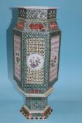 A Chinese octagonal vase with pierced fretwork panels to each side, decorated with panels of