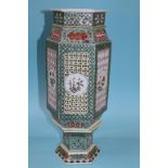 A Chinese octagonal vase with pierced fretwork panels to each side, decorated with panels of