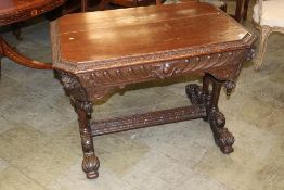 A heavily carved oak single drawer centre table, 102cm wide