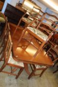 A reproduction mahogany Bevan and Funnell dining table and eight chairs