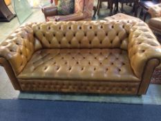 A three seater brown leather Chesterfield sofa