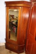 An Edwardian mahogany mirror door corner wardrobe