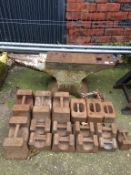 A large cast iron anvil and two weights, various