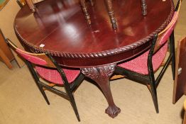 A mahogany oval dining table and four G Plan chairs