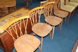 A set of four Ercol spindle back dining chairs