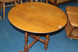 An oak circular folding table