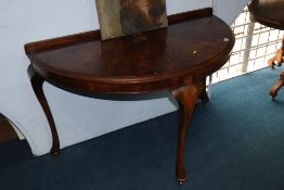 A walnut half moon hall table