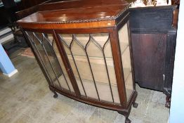 A mahogany bow front china cabinet