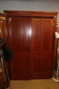 A large pine double door cupboard