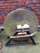 A large limestone wheel and stand. 86cm diameter