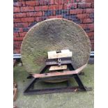 A large limestone wheel and stand. 86cm diameter