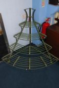 A corner graduating four tier metalwork plant stand