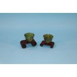 A pair of spinach coloured jade tea bowls, 4.5cm height approx.