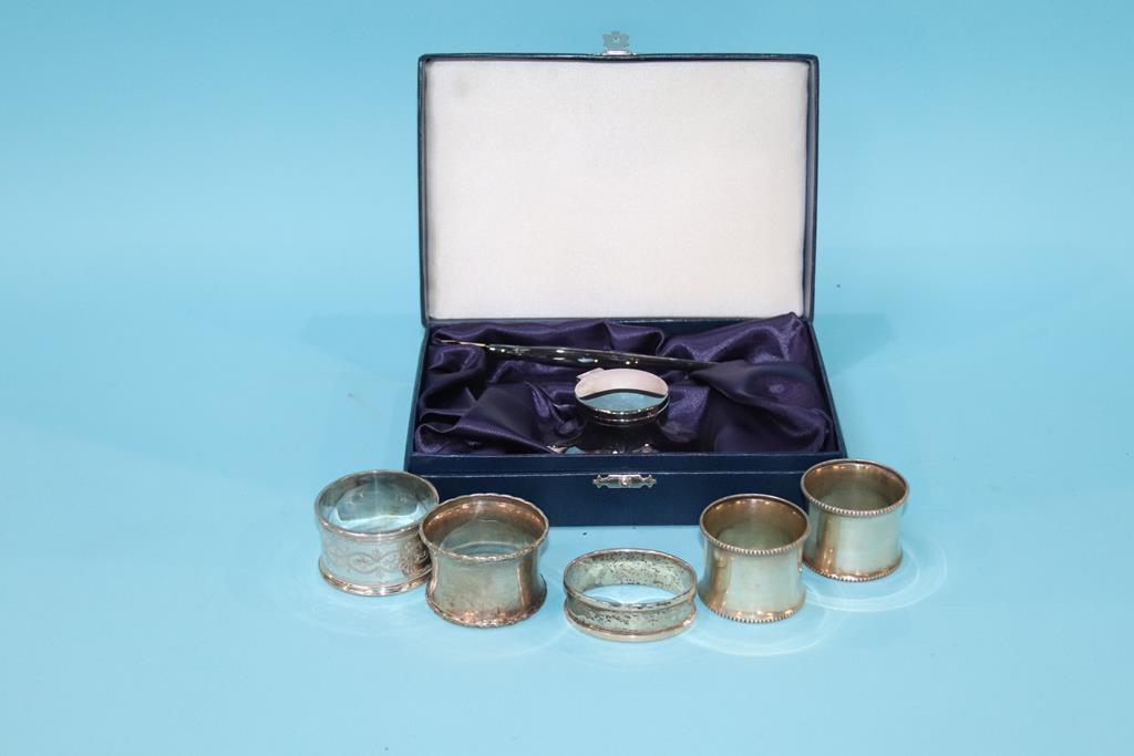 A quantity of silver napkin rings and a cased Capstan inkwell