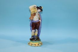 A Continental majolica figure of a man with sheaves of corn over his shoulder, 37cm height