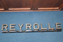 A cast metal advertising sign 'Reyrolle of Hebburn', 110cm length