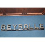 A cast metal advertising sign 'Reyrolle of Hebburn', 110cm length