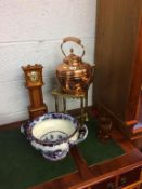 A copper kettle, trivet, clock etc.